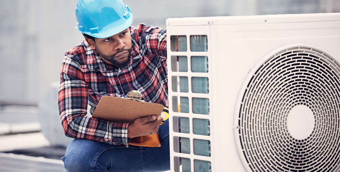 Technician repairing a heat pump